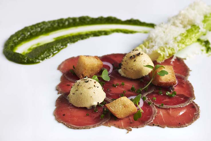 The Inn at Little Washington signature dishes A Tin of Sin (peekytoe crab and caviar with cucumber rillette), Carpaccio of Herb-Crusted Lamb Loin with Caesar Salad Ice Cream, Seasonal Tasting Menus